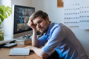 Man sleeping near computer with Zoom on it