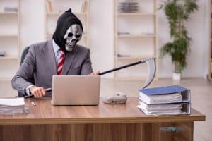The grim reaper, in a business suit, at a desk
