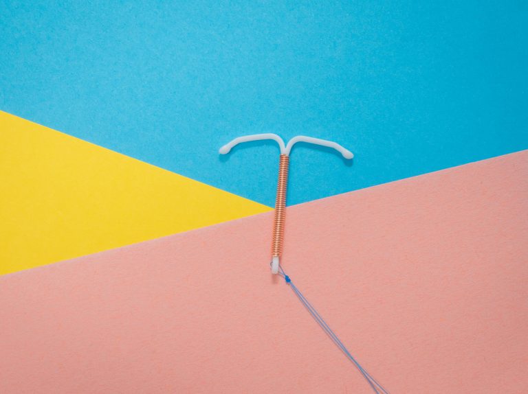 An IUD on a colourful background.