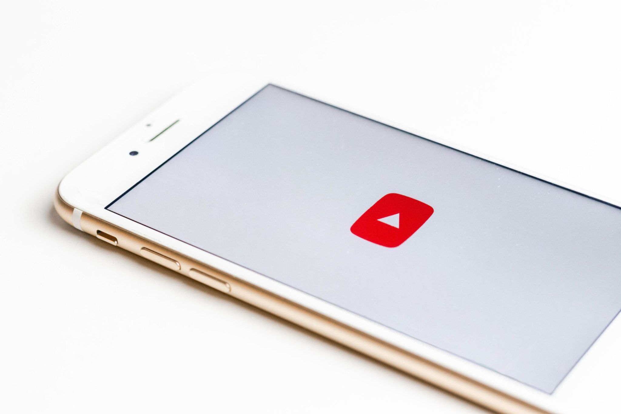 Mobile phone with YouTube logo on screen
